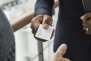 a business owner giving out his business card to a customer