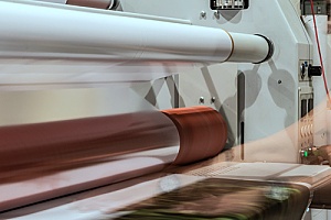 a commercial laminating machine that is working to laminate marketing collateral