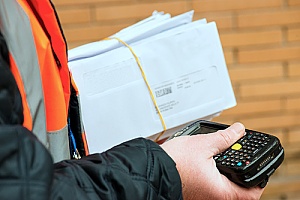 a mailman delivering business mail to an organization