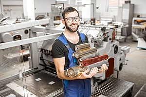 an employee performing commercial foil stamping services for an organization