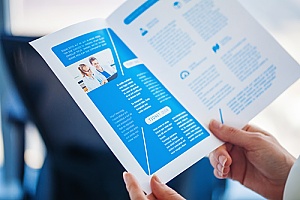 an individual reading a business brochure