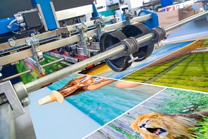 close up of an offset printing machine during production at a commercial printing company