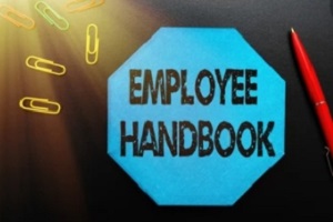 employee handbook with pen and pins