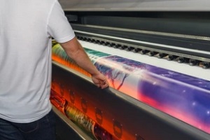 man standing with large format printing
