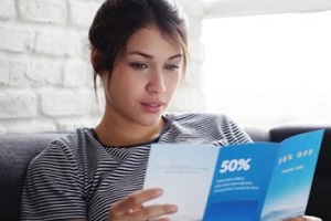 women reading business flyers