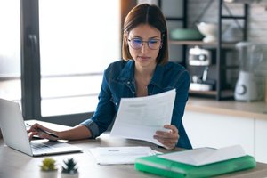 A pretty woman reading a printing services quotation