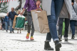 Several people leaving with shopping bags