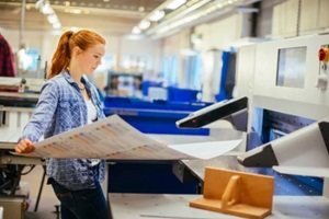 caucasian woman working in a bulk printing press office